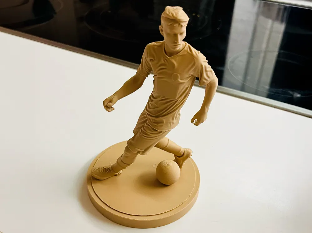 Dynamic football player sculpture